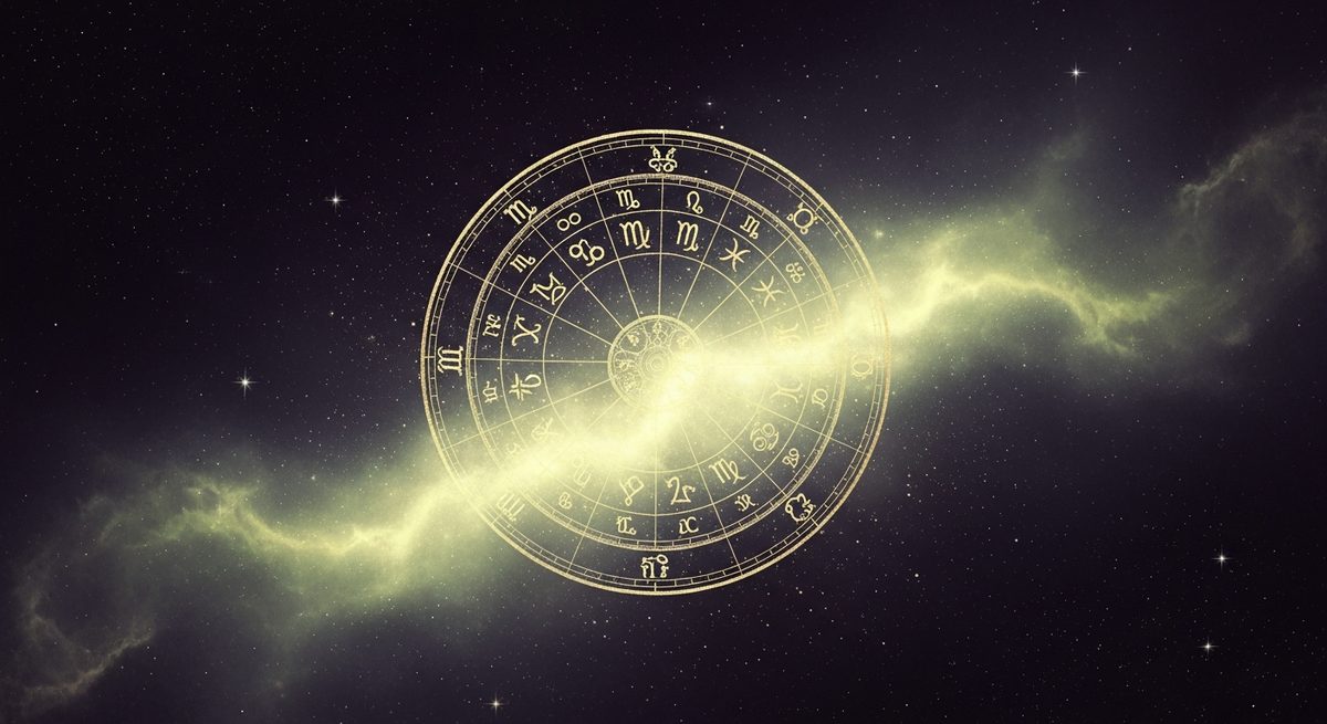 An ornate golden zodiac birth-chart wheel glowing in a nebula